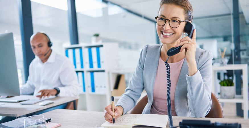 employees on phone calls in office