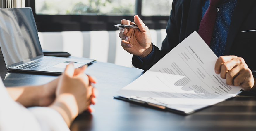 Close up of two people discussing a business leasing agreement.