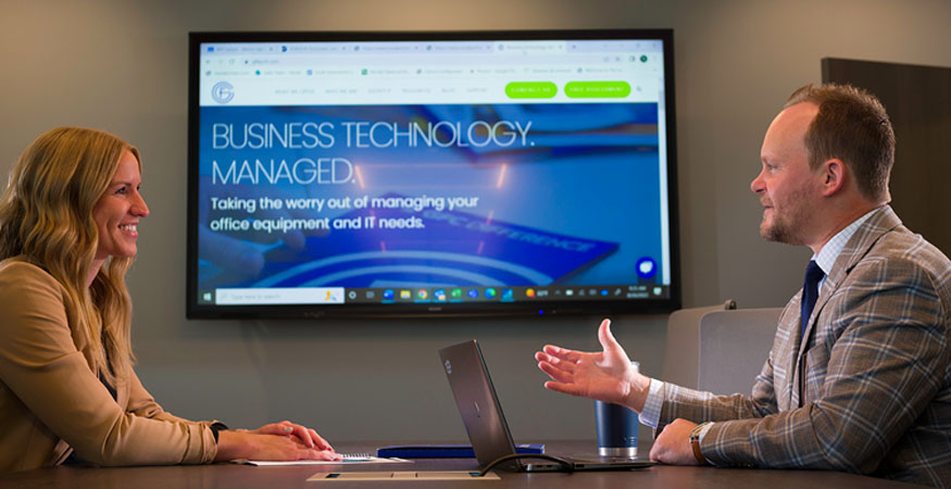 business people in a meeting room with an interactive whiteboard